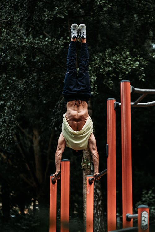 A Man Hand Standing on Parallel Bars