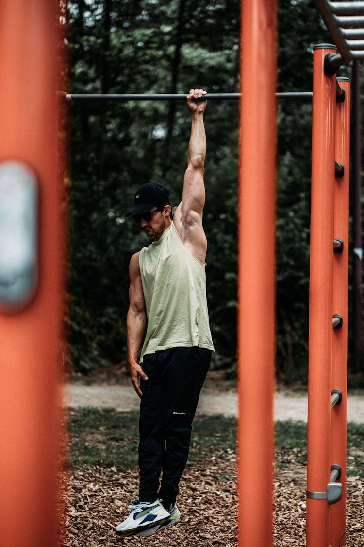 A Person Hanging On The Bar 