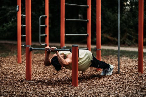 A Man Doing Pull Ups Exercise on Steel Bar