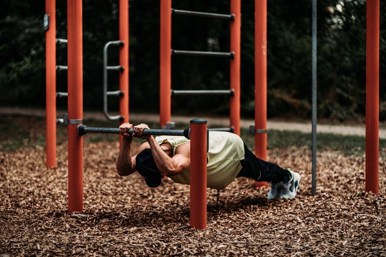 A Man Doing Pull Ups Exercise On Steel Bar