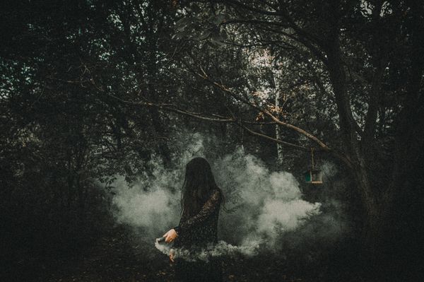 Figure in smoke among trees — Helena Jankovicova Kovacova on Pexels