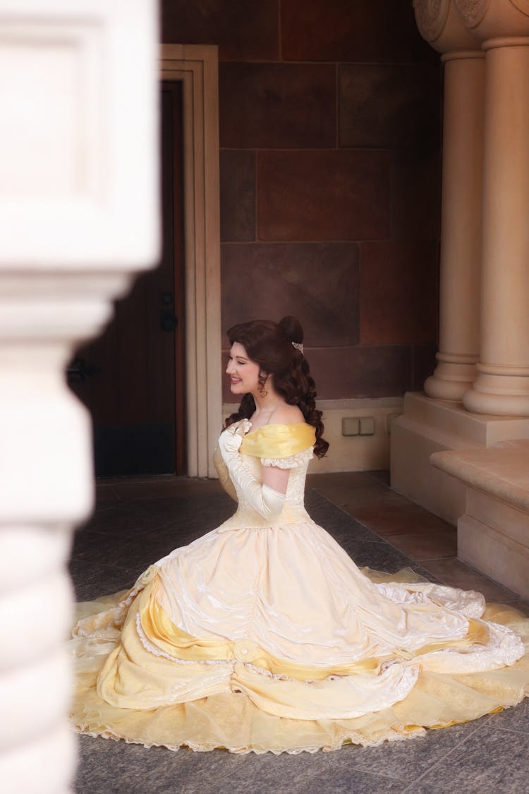 Woman In White And Yellow Gown In A Theatre