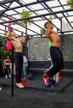 Men performing pull-ups during an outdoor crossfit workout in Mexico City gym.