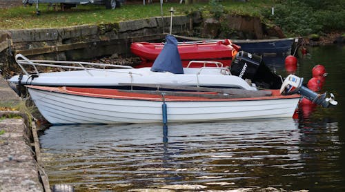 Watercrafts Docked on the Side of the River