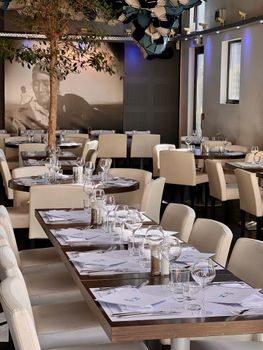 Stylish restaurant interior featuring elegant table settings ready for guests.