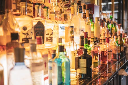Assorted Liquor Bottles on a Rack