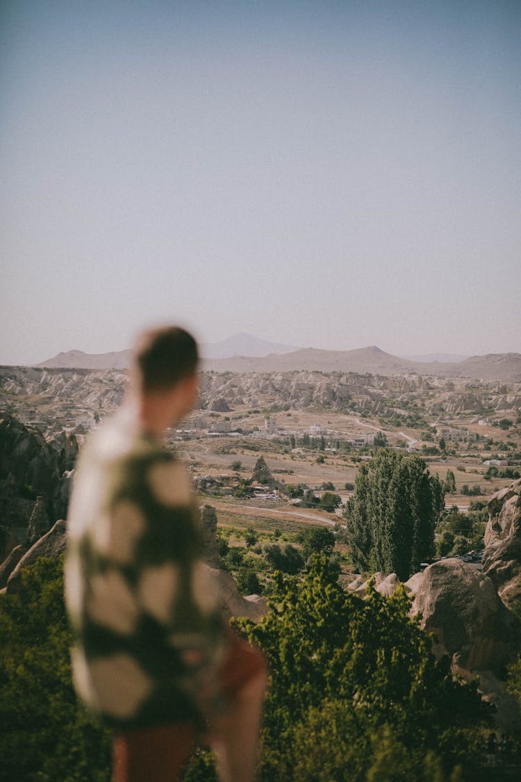 Man On Mountain Peak Looking At Cappadocia View