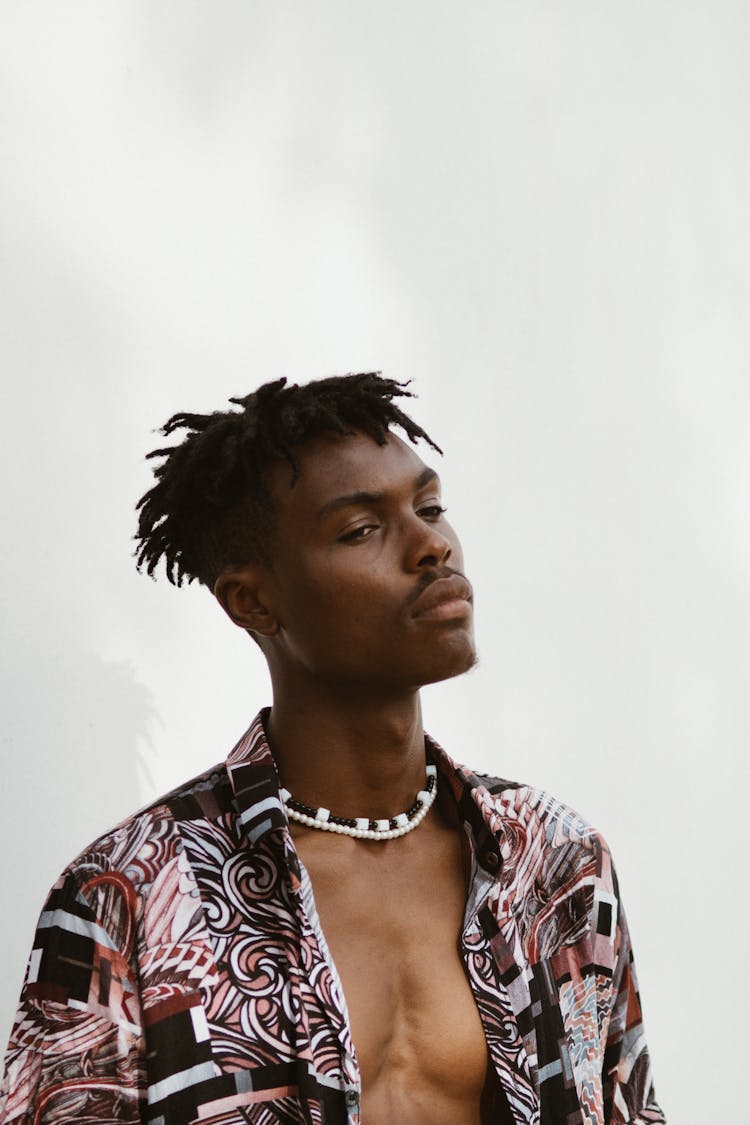 Young Man In Floral Shirt On White Background