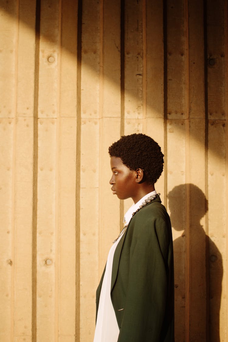 Side View Of Woman Posing On Wooden Wall Background