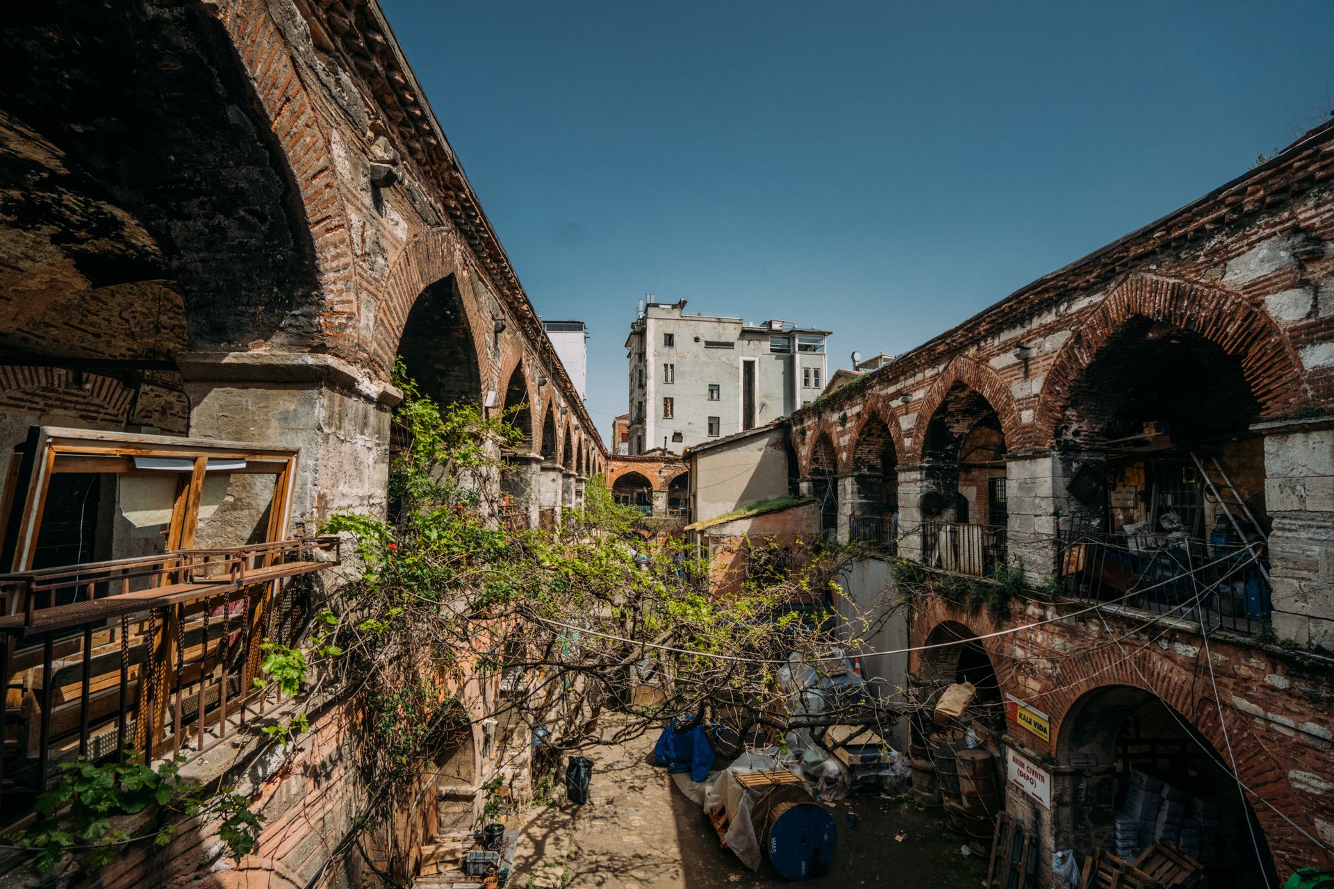 An old brick arch in a daylit courtyard
