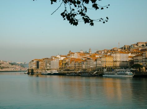 A scenic view of Porto's waterfront buildings and boats along the riverbank.