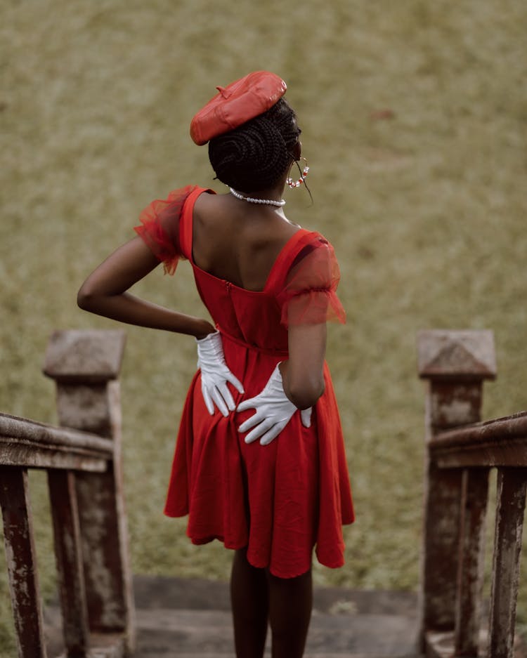 Woman In Red Dress Standing On Top Of Old Stairs