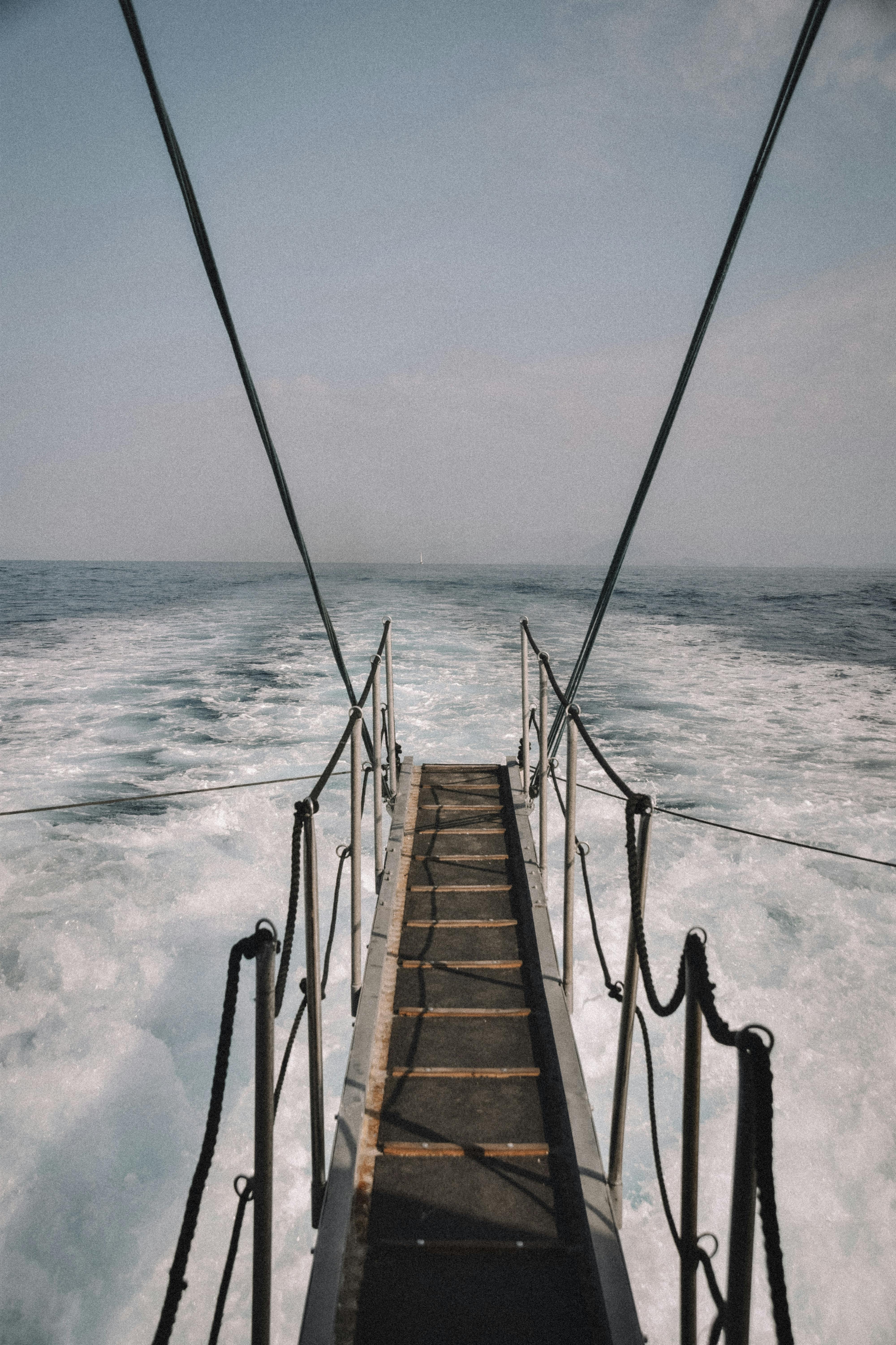 A scenic view of the ocean from a boat pier in Corfu, Greece with waves and sky.