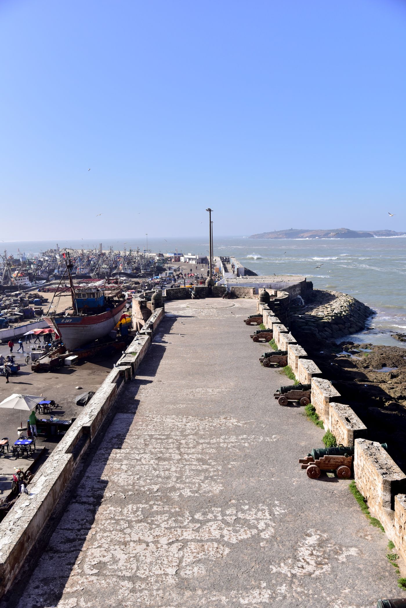 Fishing boats and historic harbour walls in Essaouira, Morocco