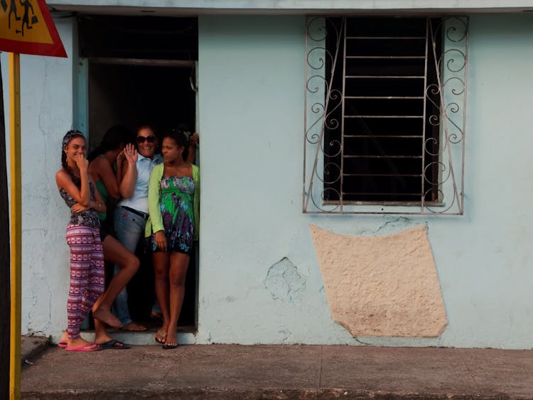 Mother With Teenage Daughters Standing In Door