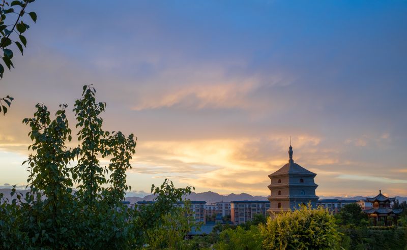 Big Wild Goose Pagoda rising above trees at sunset in Xi'an