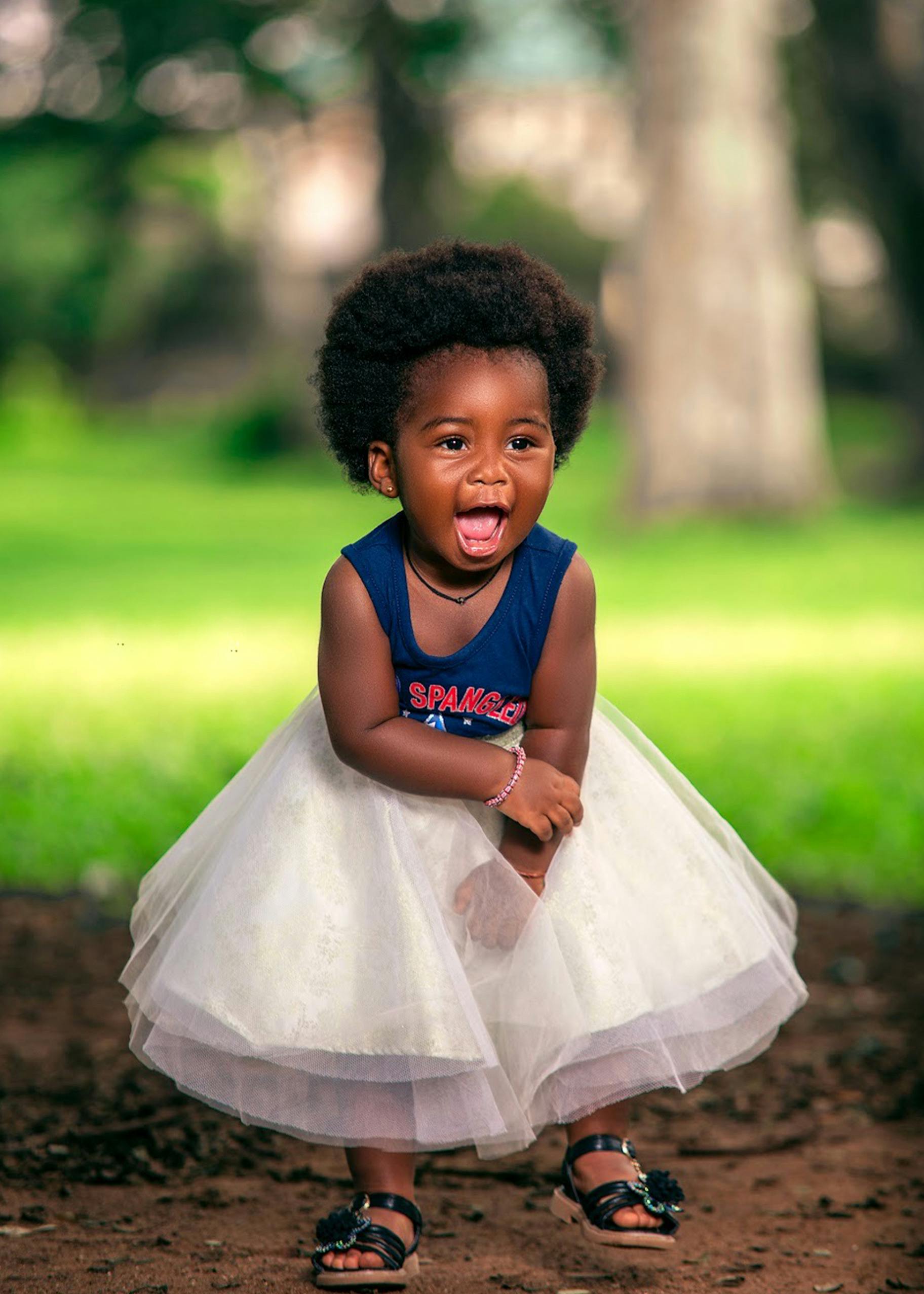Baby Girl Wearing Blue Tank Top and White Skirt in a Park · Free Stock