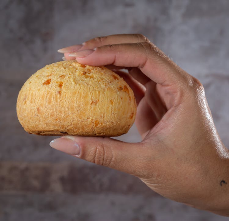 A Person Holding A Bread 