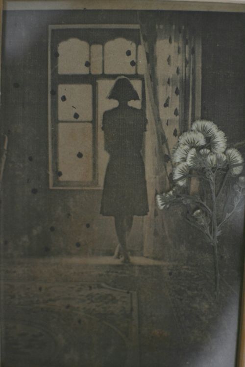 Free Ethereal silhouette of a woman standing by a window in a vintage setting. Stock Photo