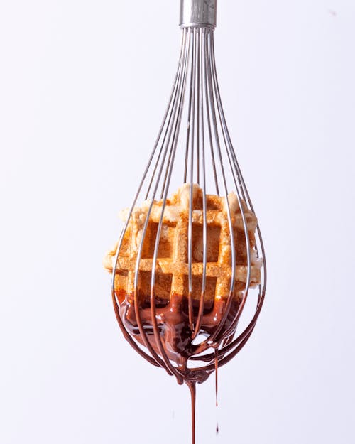 Close-up of a Whisk with Waffle and Chocolate 