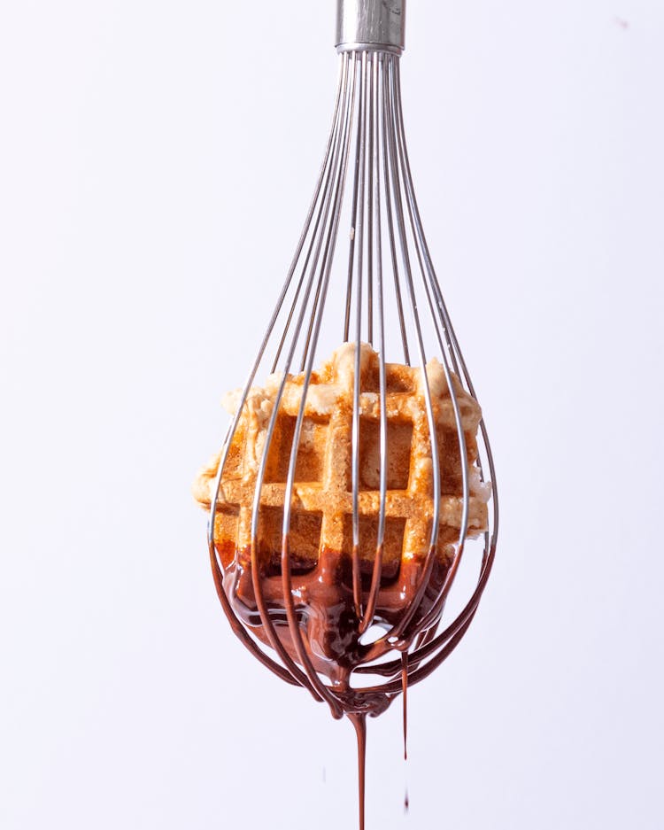 Close-up Of A Whisk With Waffle And Chocolate 