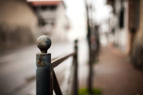 Selective Focus Photography of Black Metal Rail