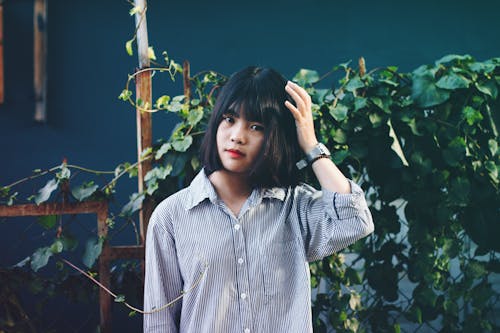 Woman Standing Behind Vines