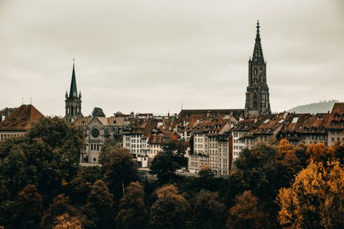 Free Explore the gothic architecture and vibrant autumn colors of Berne's cityscape from an elevated viewpoint. Stock Photo