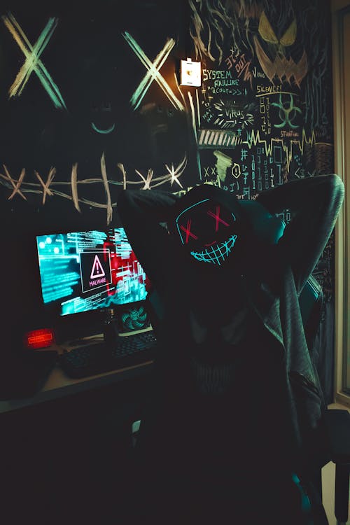 Masked Person by Computer · Free Stock Photo