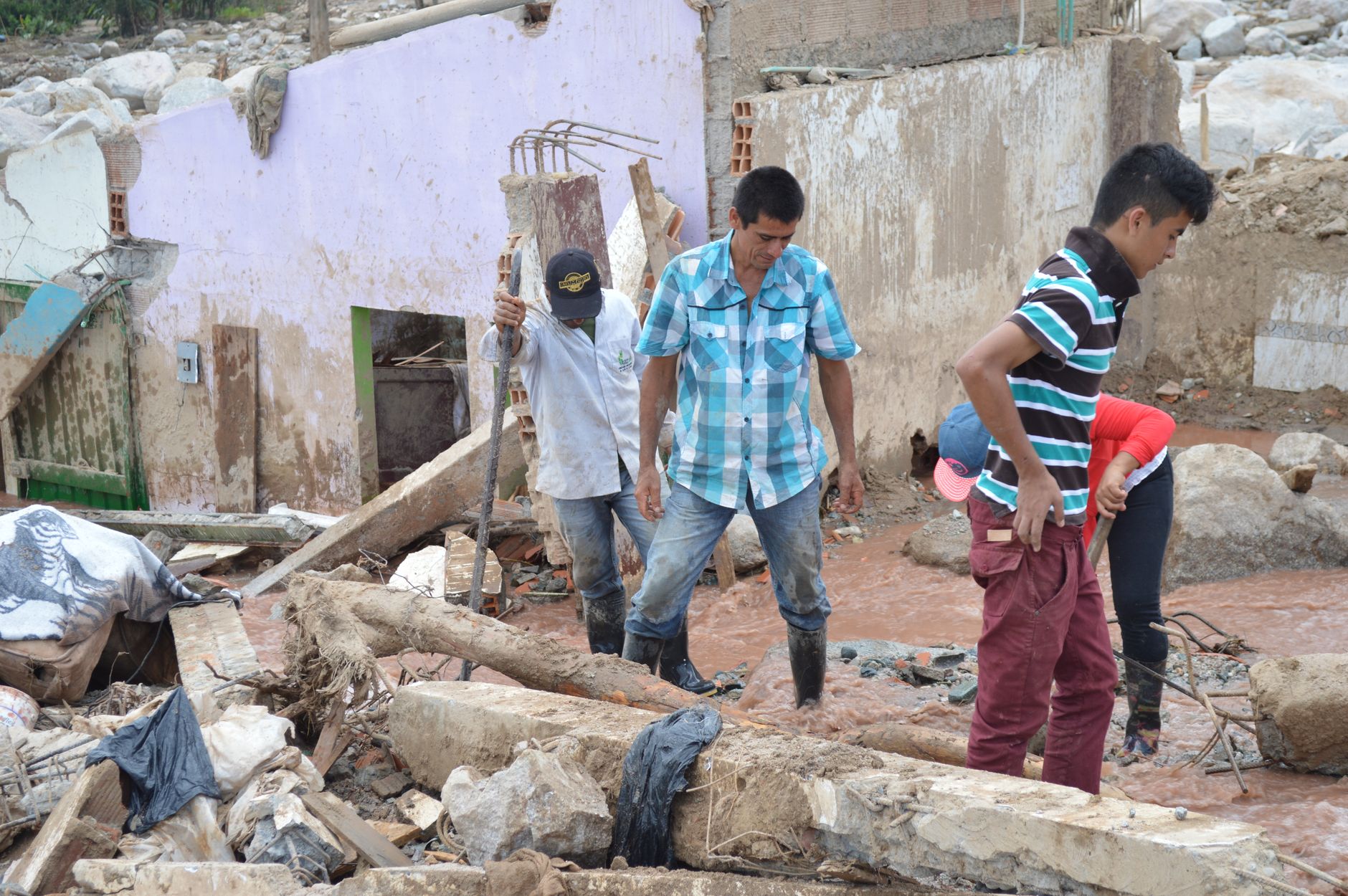 Survivors navigate debris in Mocoa after a devastating natural disaster.