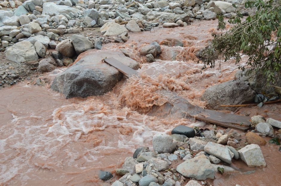 swollen mountain stream muddy fast current