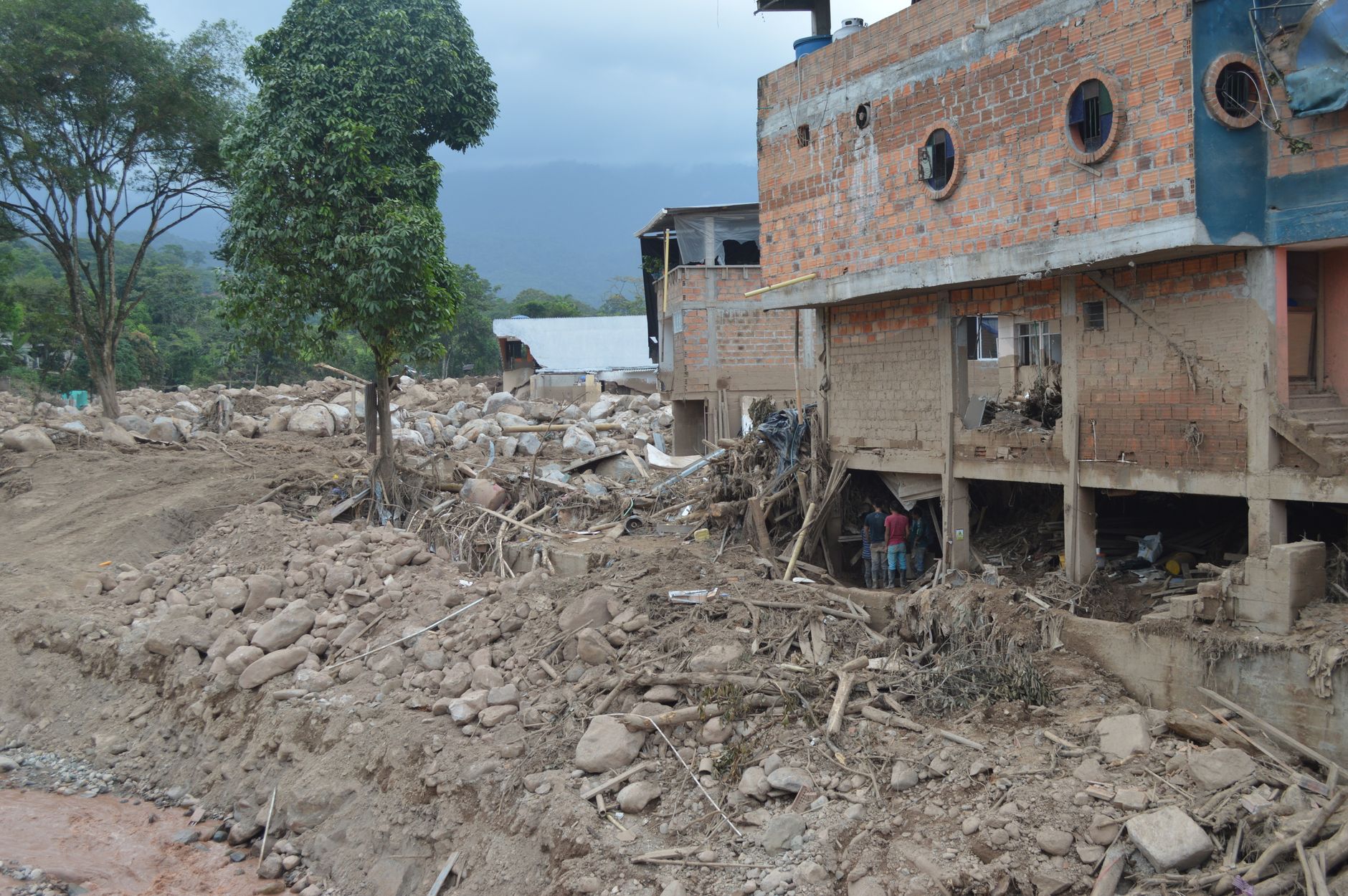 Destruction from landslide in Mocoa, Colombia, showing damaged buildings and debris.