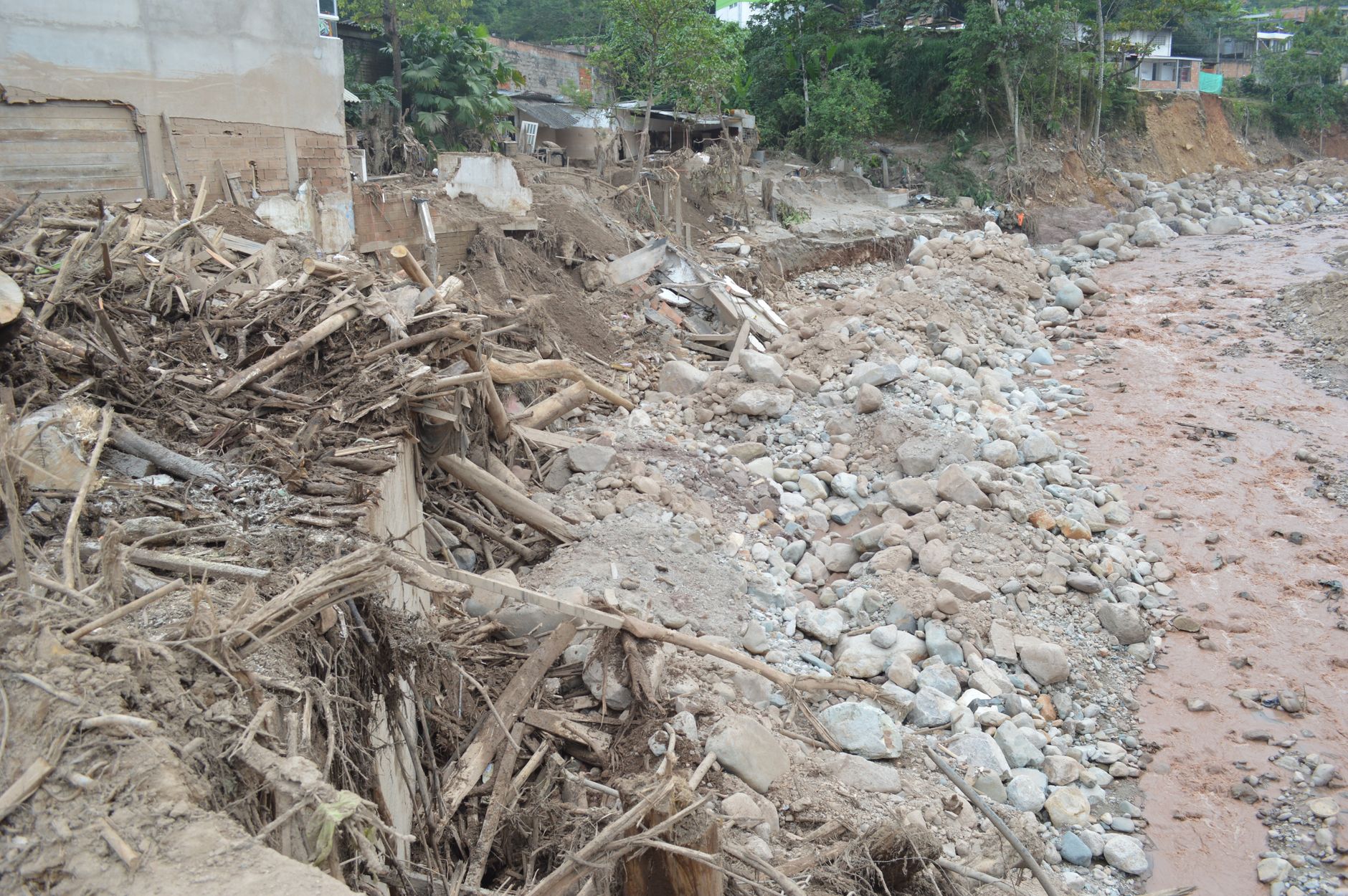 Erosion and debris visible along the dried riverbed in Mocoa, Colombia.