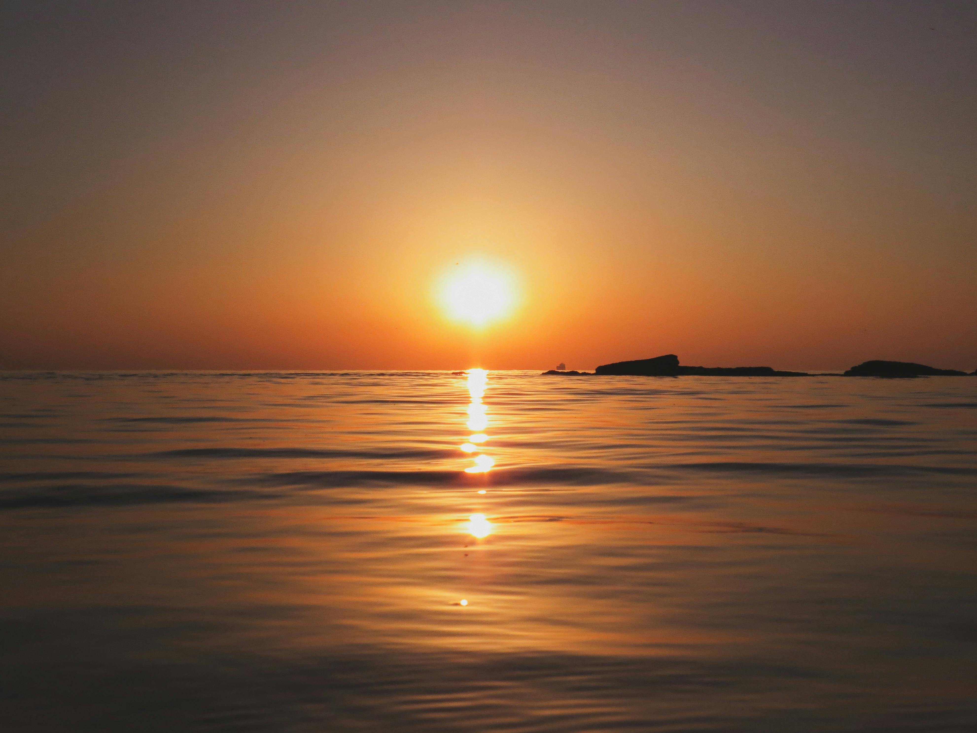 Sun Setting on Horizon at Sea · Free Stock Photo