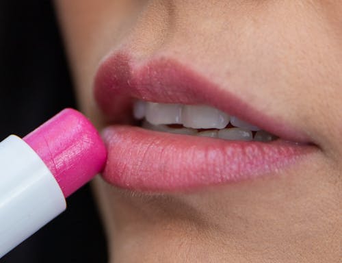 A Person Applying Pink Lipstick 
