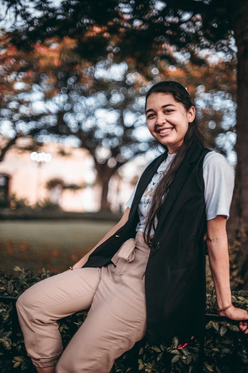 A Woman in Black Vest Blazer and Brown Pants