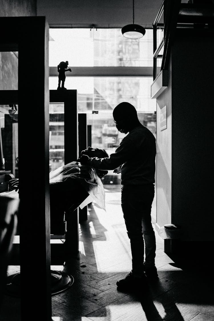 Black And White Photo Of Two Men In A Barber Shop