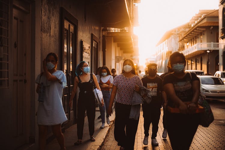 A People Wearing Face Mask While Walking Outside