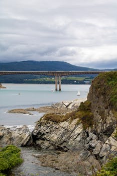 Stunning landscape of Puente de los Santos bridge over the river in Ribadeo, Spain, with natural surroundings.