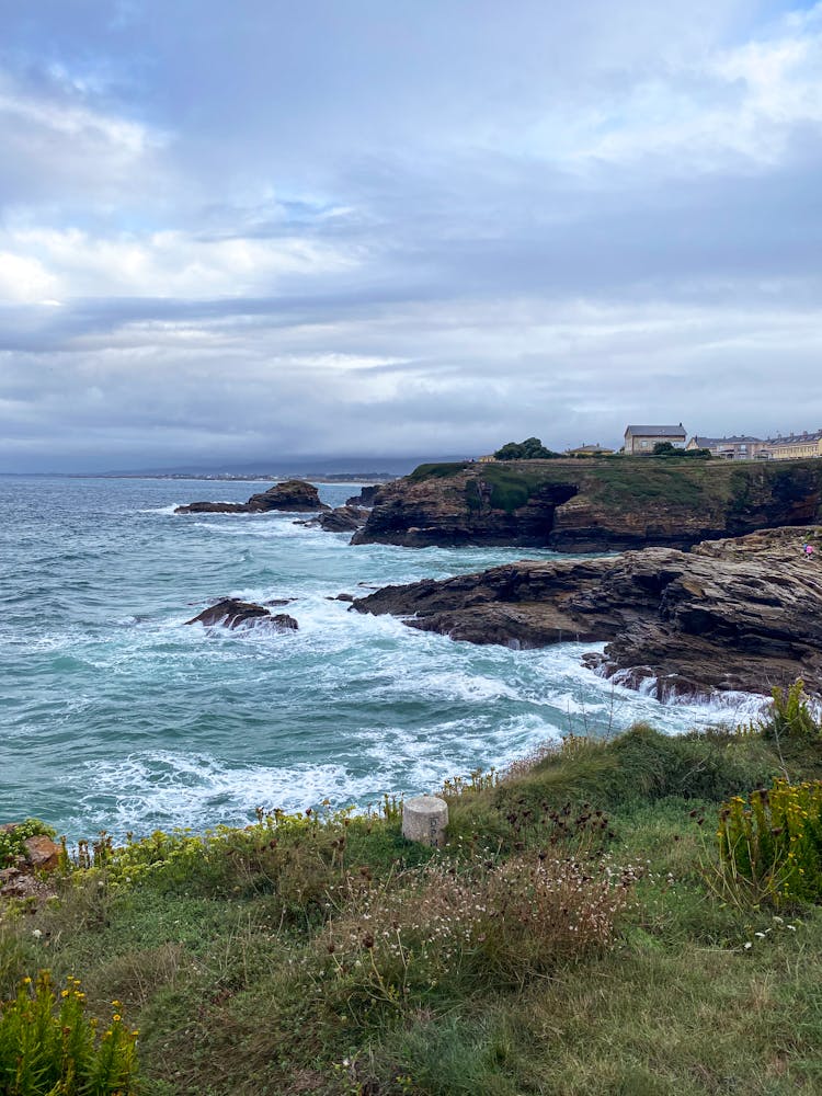 Waves Crashing On The Coastal Cliff