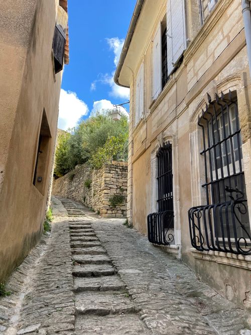 Free Rustic stone alley in Gordes, Provence, showcasing classic French architecture under a bright sky. Stock Photo