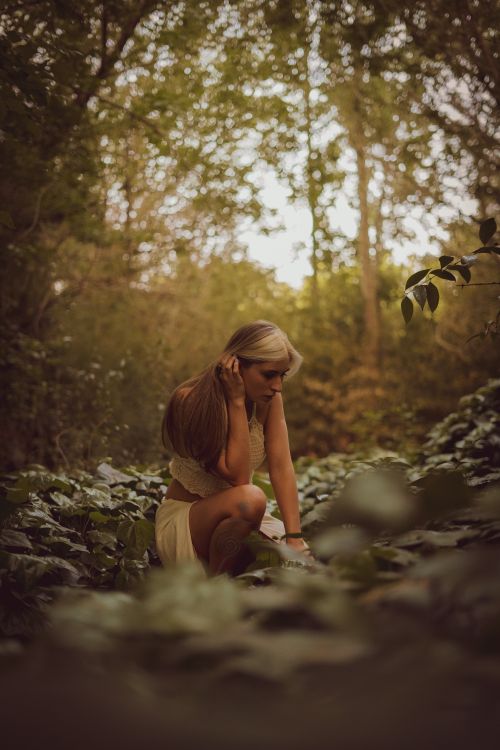 Woman Sitting on Ground in Forest · Free Stock Photo
