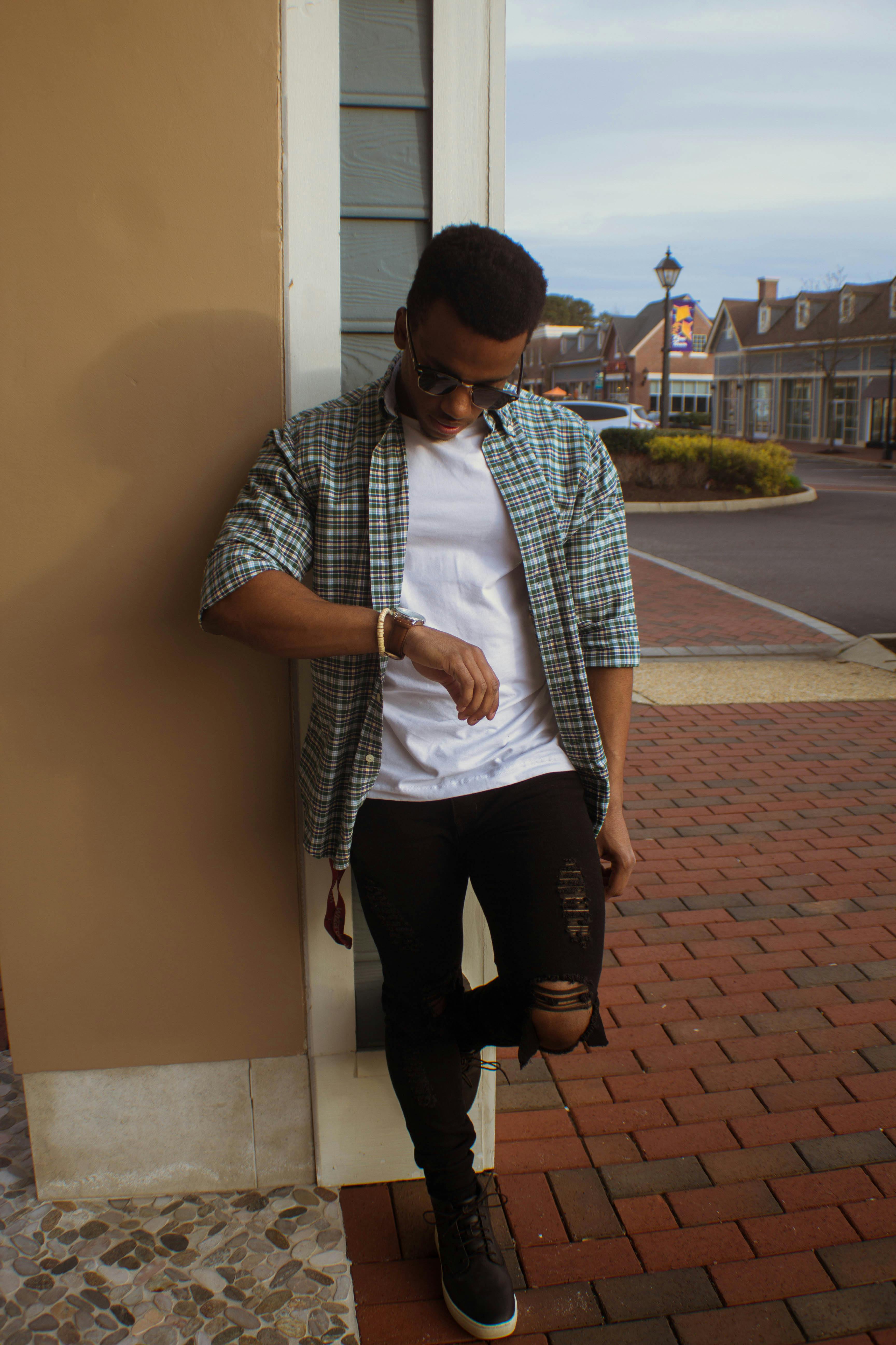 Man in Gray Hoodie and Black Pants Standing on Brown Brick Stairs · Free  Stock Photo