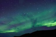 Stunning display of the aurora borealis illuminating the night with vibrant hues and stars.