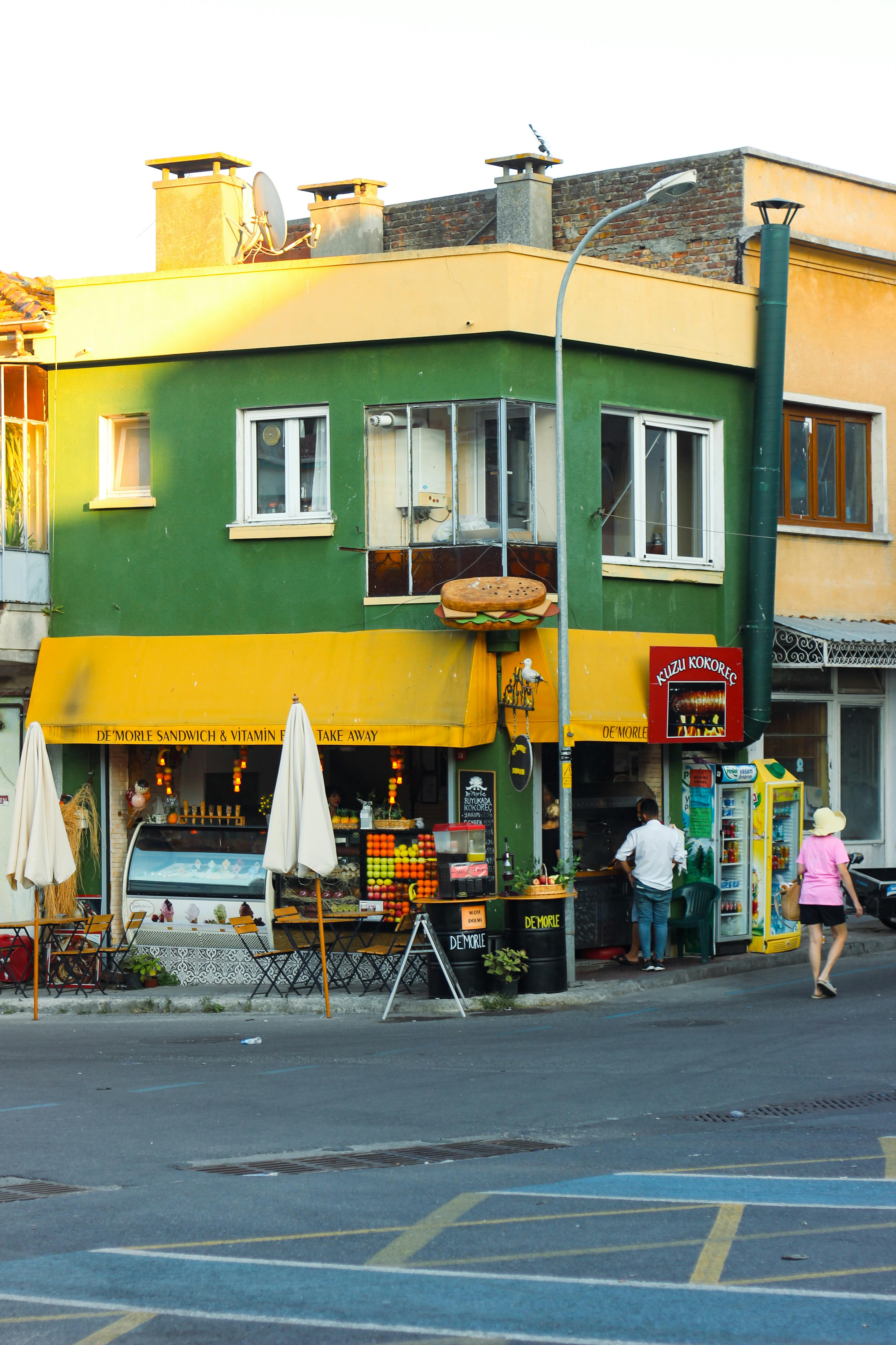 Free Vibrant corner market with fresh fruit and vintage architecture on a sunny day. Stock Photo