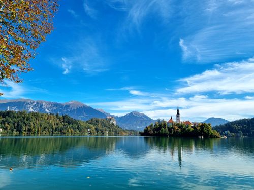 Free Peaceful view of Lake Bled with church island and Julian Alps on a sunny day. Stock Photo