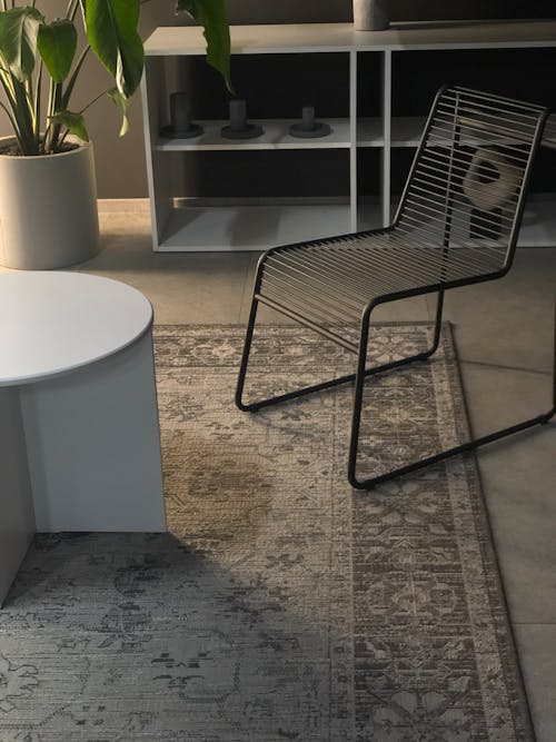 Steel Chair by Coffee Table in Dimly Lit Room