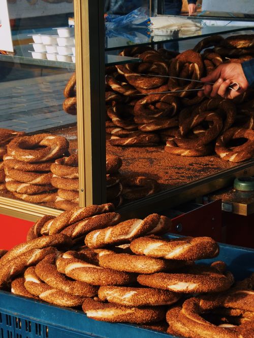 Free Delicious simit freshly prepared at a bustling street stand in Istanbul, Turkey. Stock Photo