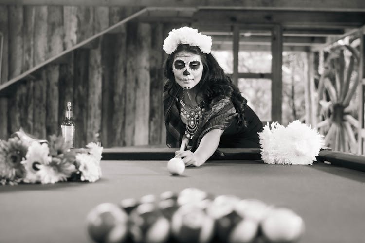 Black And White Photo Of A Woman In A Death Mask Playing Billiard