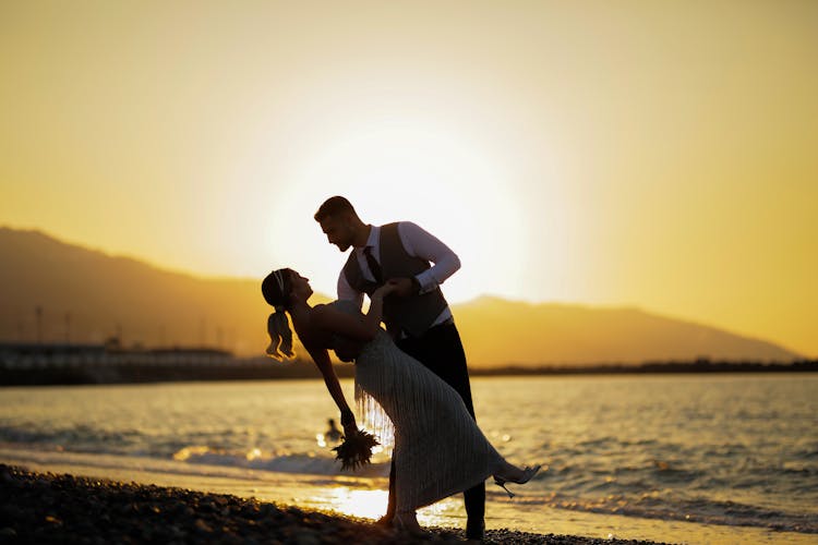 Newlywed Couple Dancing At Beach